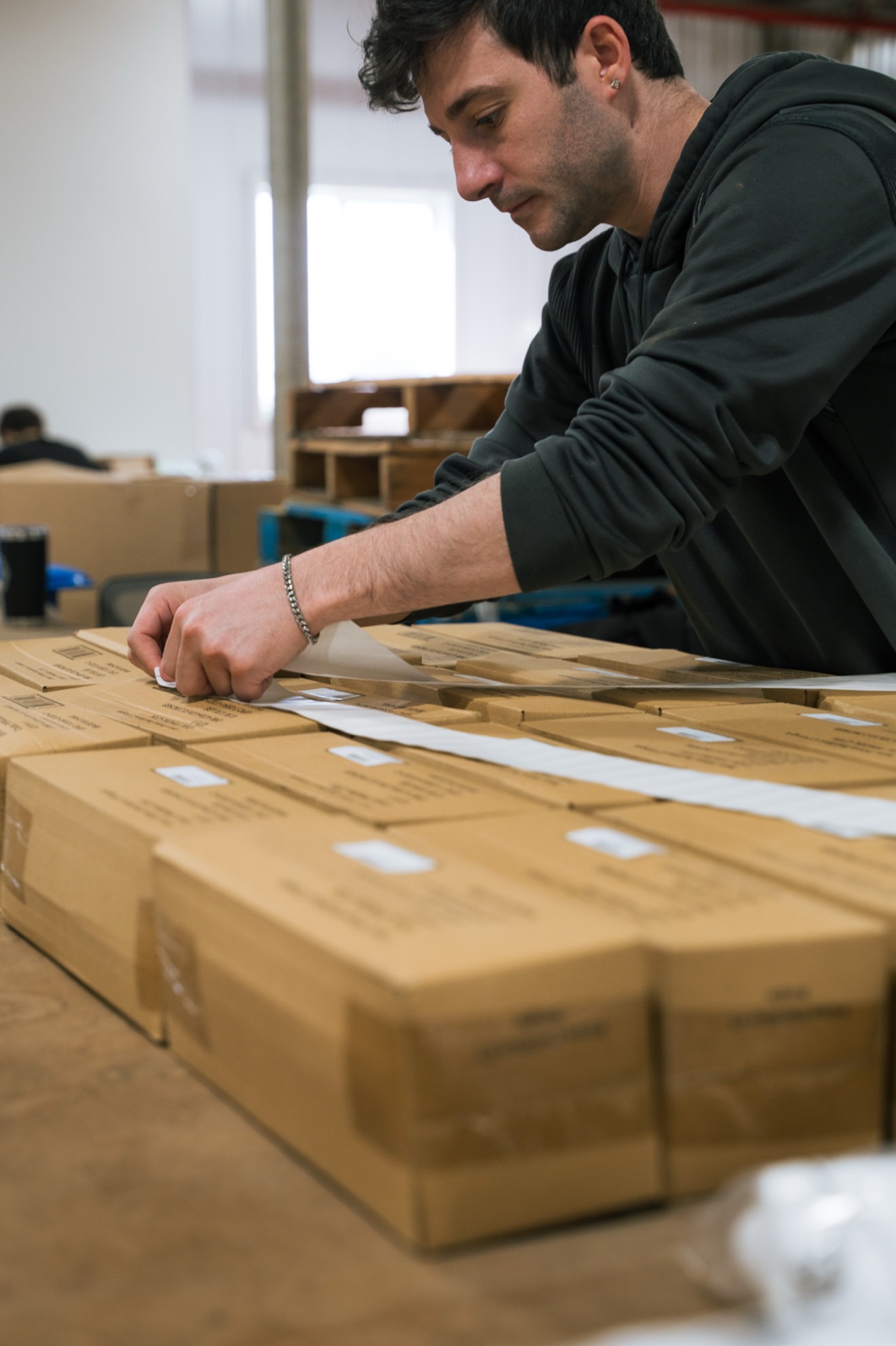 Orders being boxed and taped for shipping